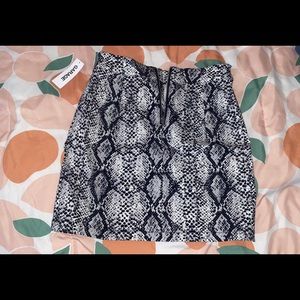 Selling a snake print mini skirt. Never been worn and tags are still on!